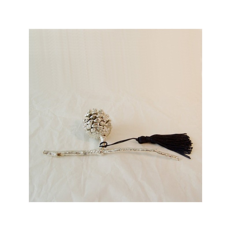 Silver pine cone on a branch, real plant silver plated.