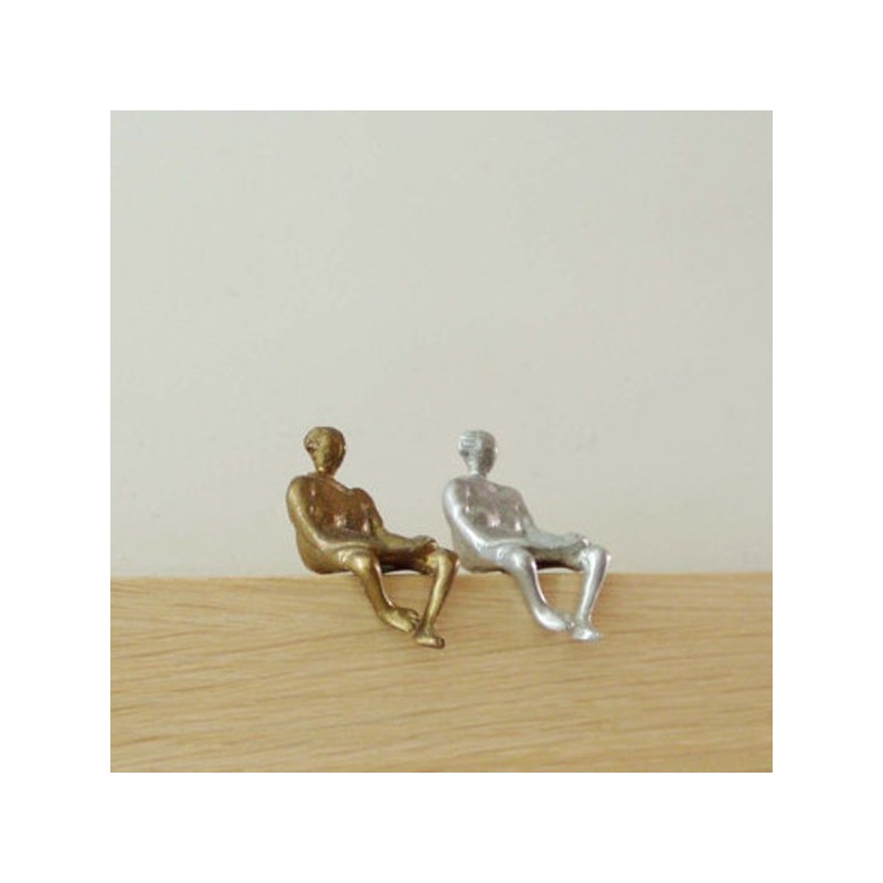 Metall sculpture of seated woman