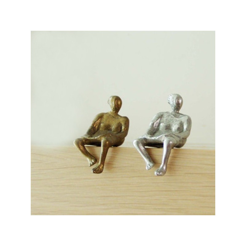 Metall sculpture of seated woman