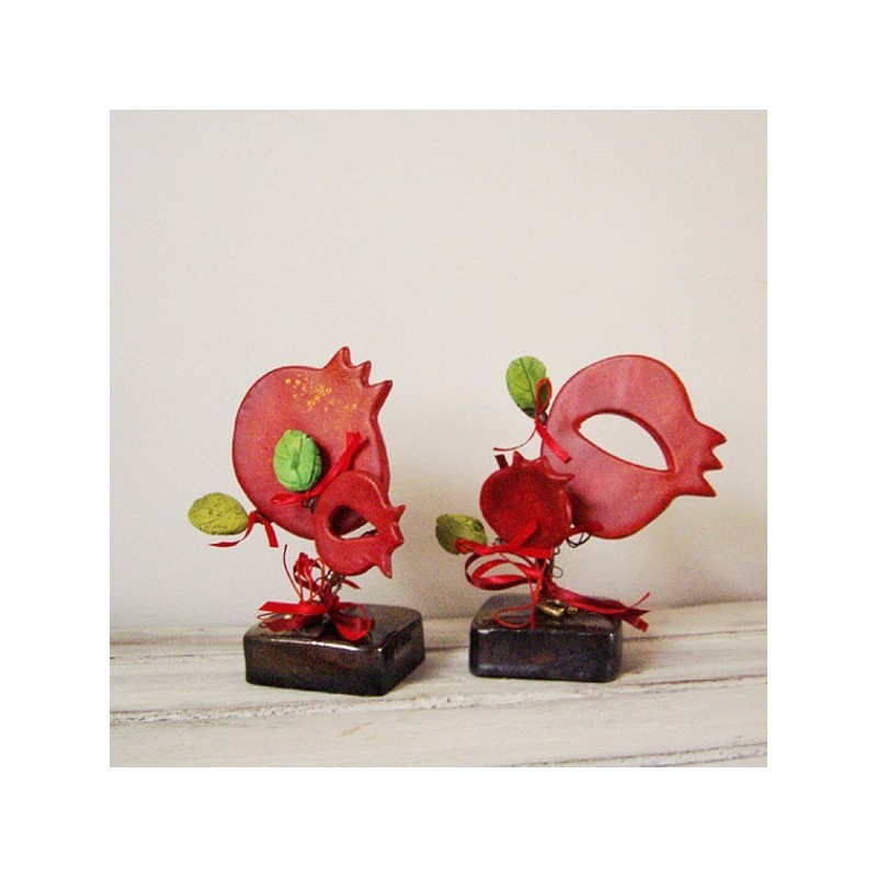 Red pomegranates sculpture, set of two pomegranates on brown, square base with green leaves and ribbons