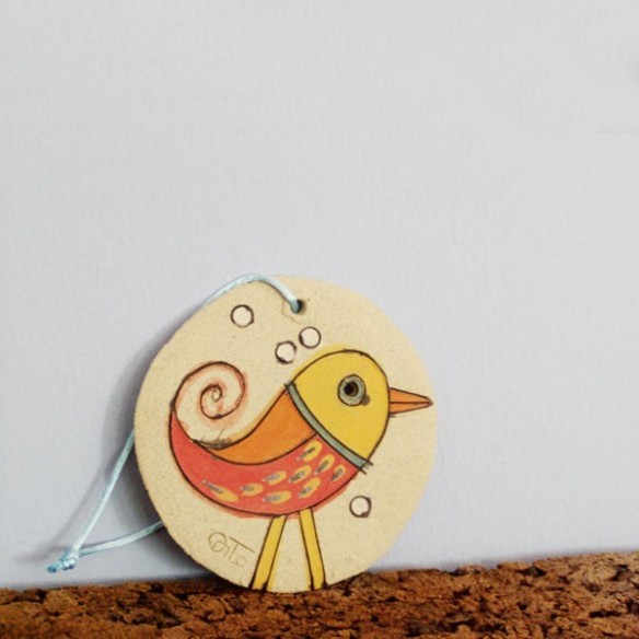 Christmas tree ornament of round ceramic tile with merry bird illustration, bird ceramic ornament.