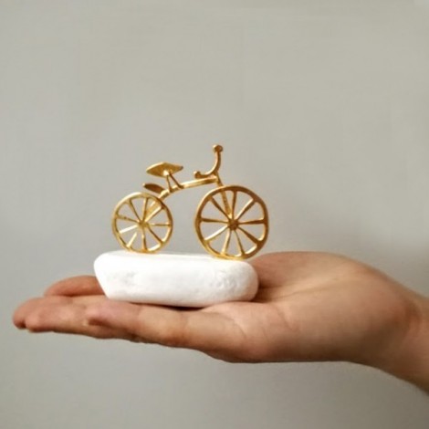 Gold bicycle sculpture, miniature bike sculpture on white stone, gold bike on white stone. 2