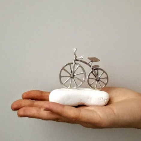 Silver bicycle sculpture, mini bike sculpture on white stone, silver bike on white stone. 2