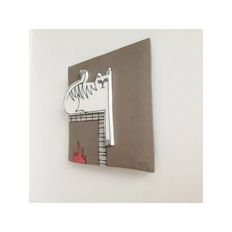 White cat wall hanging, porcelain cat in grey background, square wall tile of stoneware and porcelain, cat on the fireplace