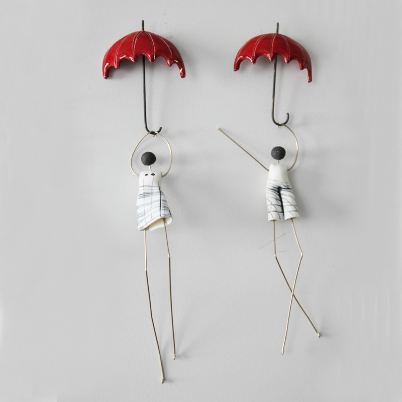 Figures with umbrella sculptures,...