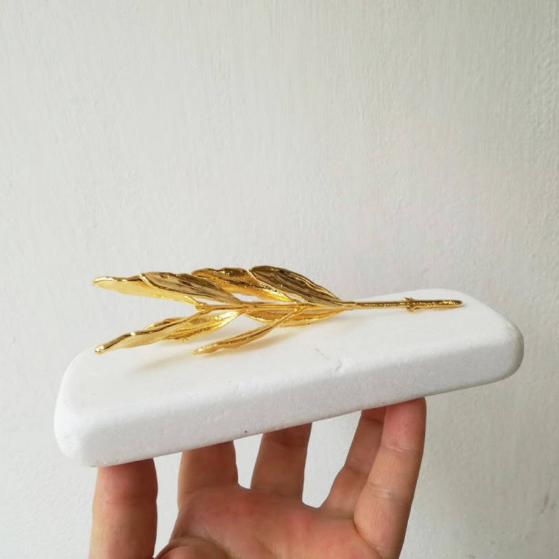 Gold olive branch on white marble,...