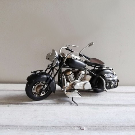 Black motorcycle miniature, retro collectible miniature of black, vintage motorbike with black saddlebags on the sides