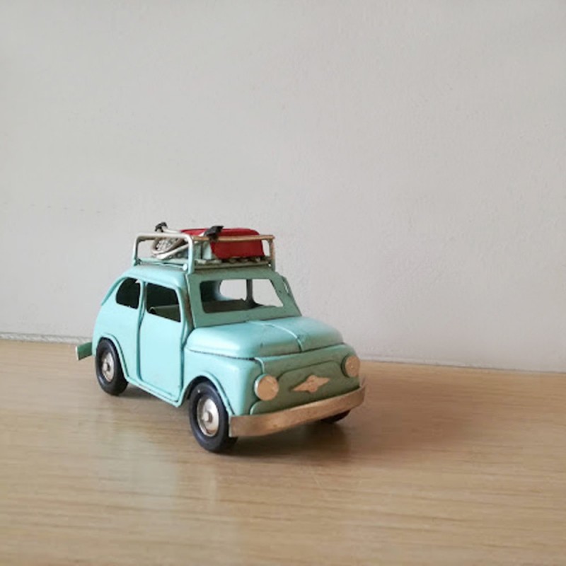 Fiat style car miniature, retro collectible miniature, turqoise blue Fiat 500 with baggage on the rack