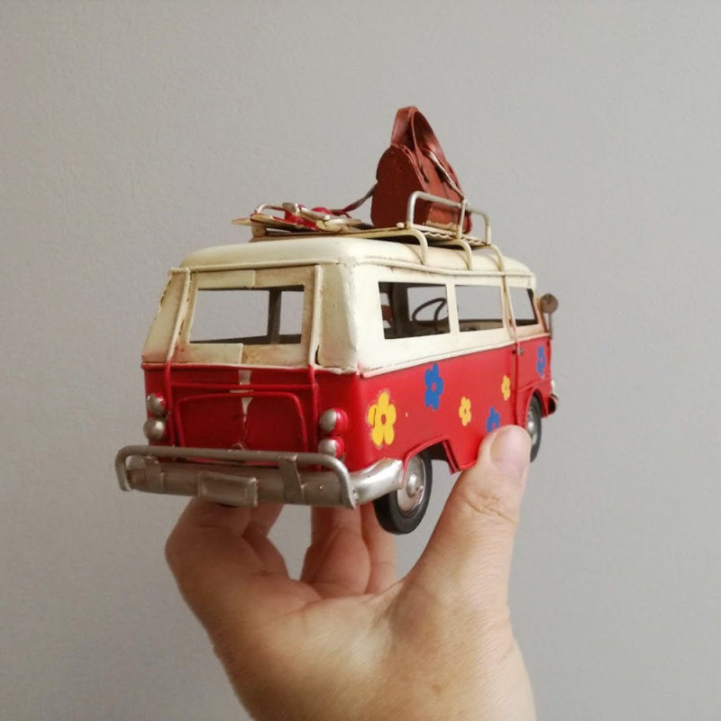 Red and white VW van, retro collectible metal VW van miniature, with two surfboards on baggage rack, collectors item