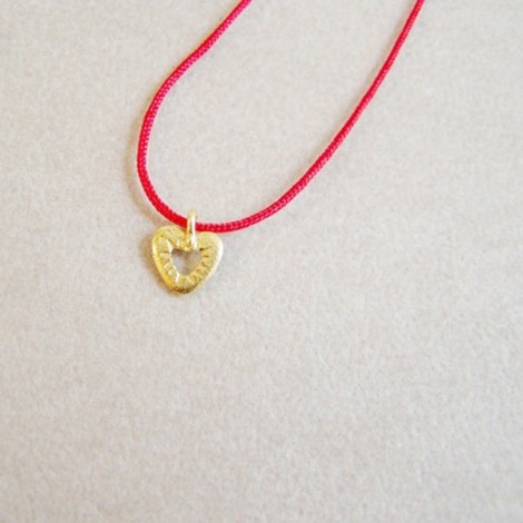 Tiny gold heart pendant on...