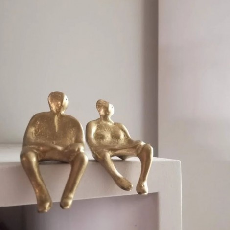 Seated couple figures, brass sculptures of a man and a woman