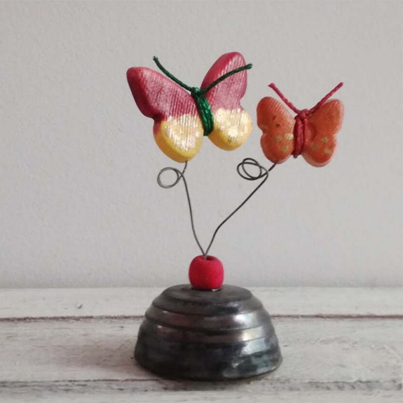 Multi colored ceramic butterflies on square ceramic base
