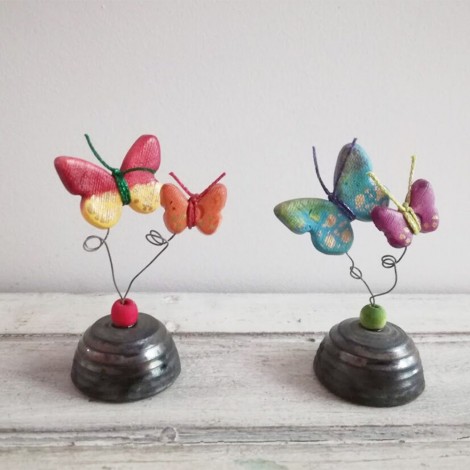 Multi colored ceramic butterflies on square ceramic base
