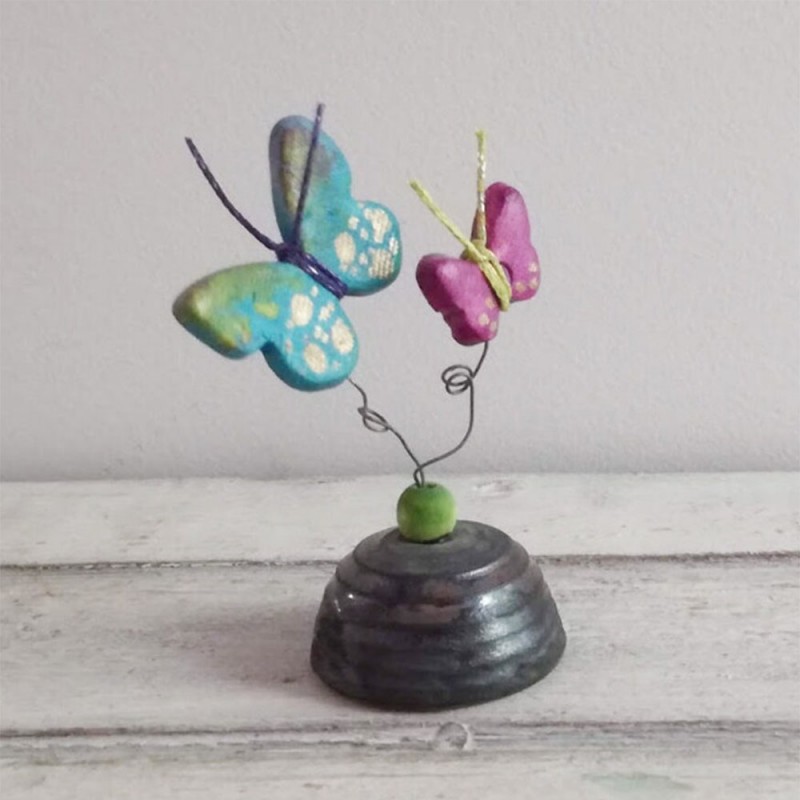 Multi colored ceramic butterflies on square ceramic base