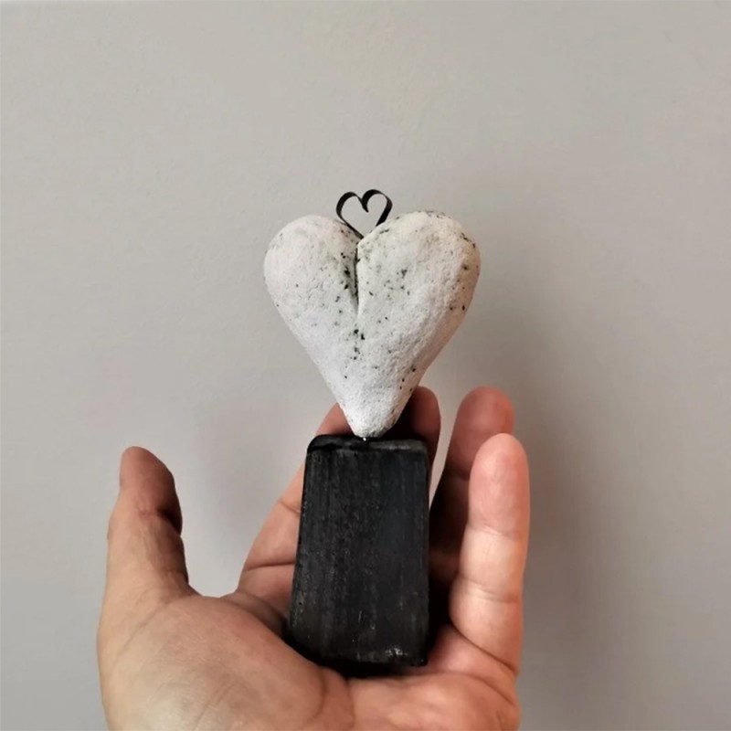 White heart sculpture, ceramic heart of stoneware clay on black, rectangle base
