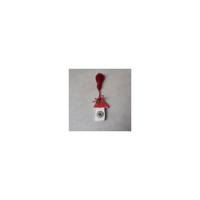 A red roof house ornament with a New Year '24 charm