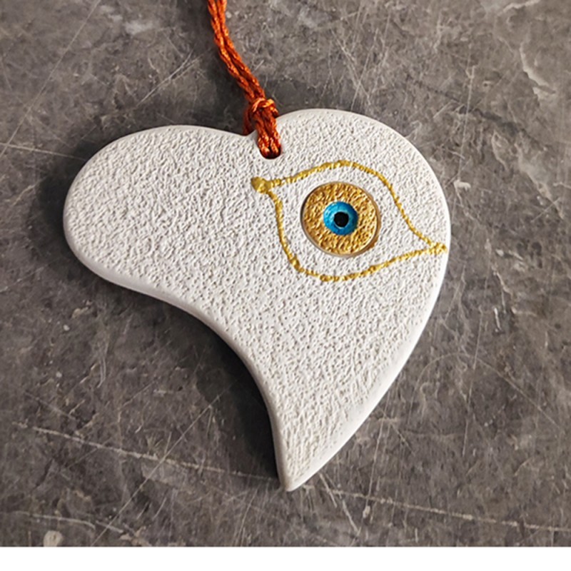 This is a ceramic heart ornament, made of earthenware clay.