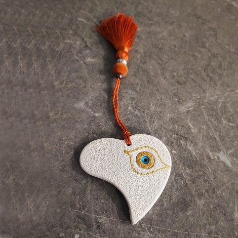This is a ceramic heart ornament, made of earthenware clay. 2