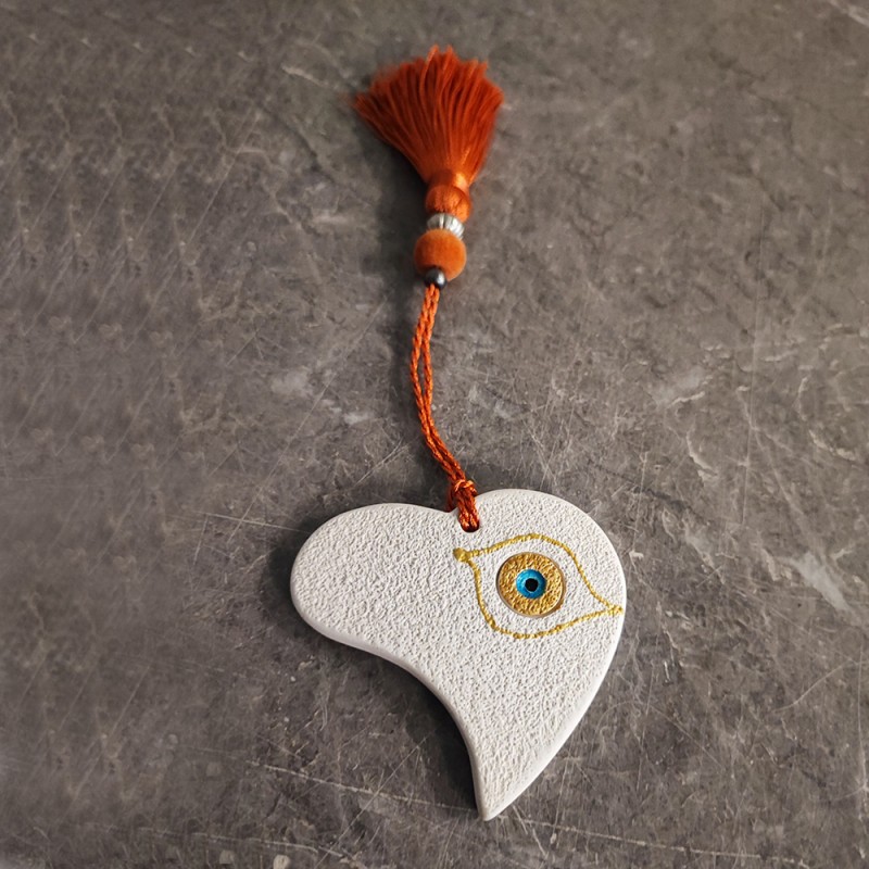 This is a ceramic heart ornament, made of earthenware clay.