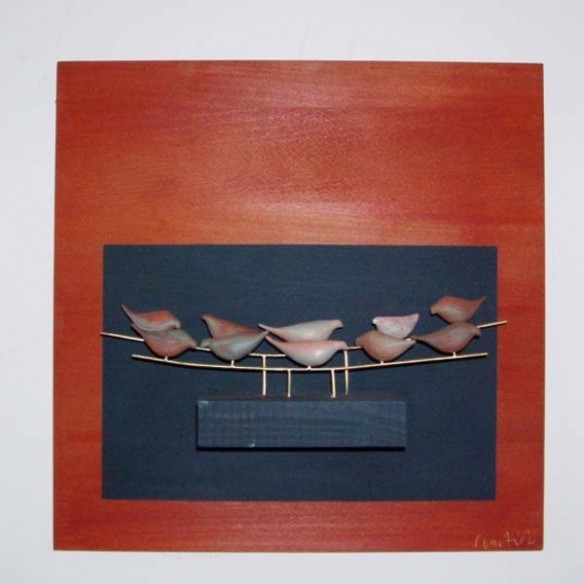 Ceramic birds on a wooden background, wall sculpture