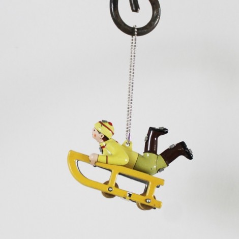 Yellow sled tree ornament with child in winter clothes, yellow sled old toy style, vintage collectible miniature.