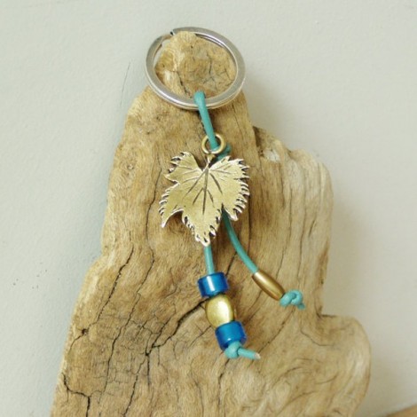 Grapevine keychain, brass grapevine leaf on a blue leather cord with brass and glass beads.