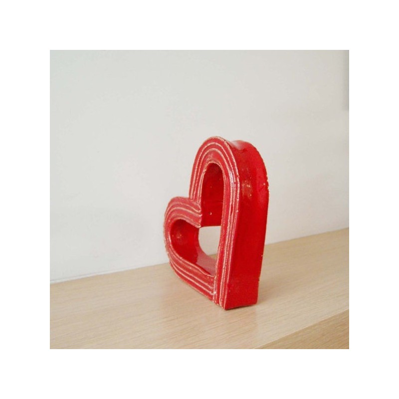 Red ceramic heart outline sculpture.