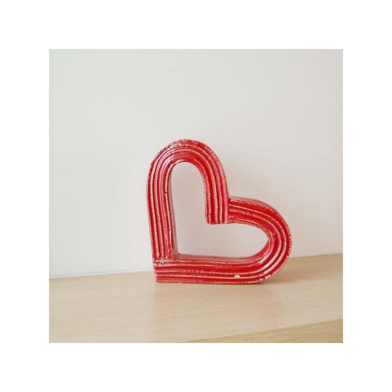 Red ceramic heart outline sculpture.