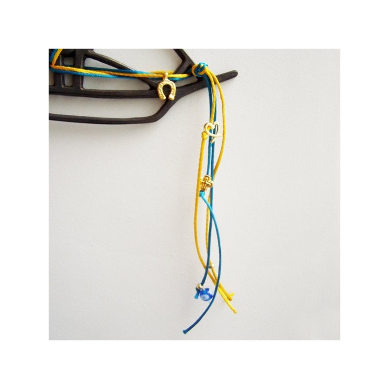 Metal sailboat wallhanging, oxidised brass outline of a boat with satin cords and charms