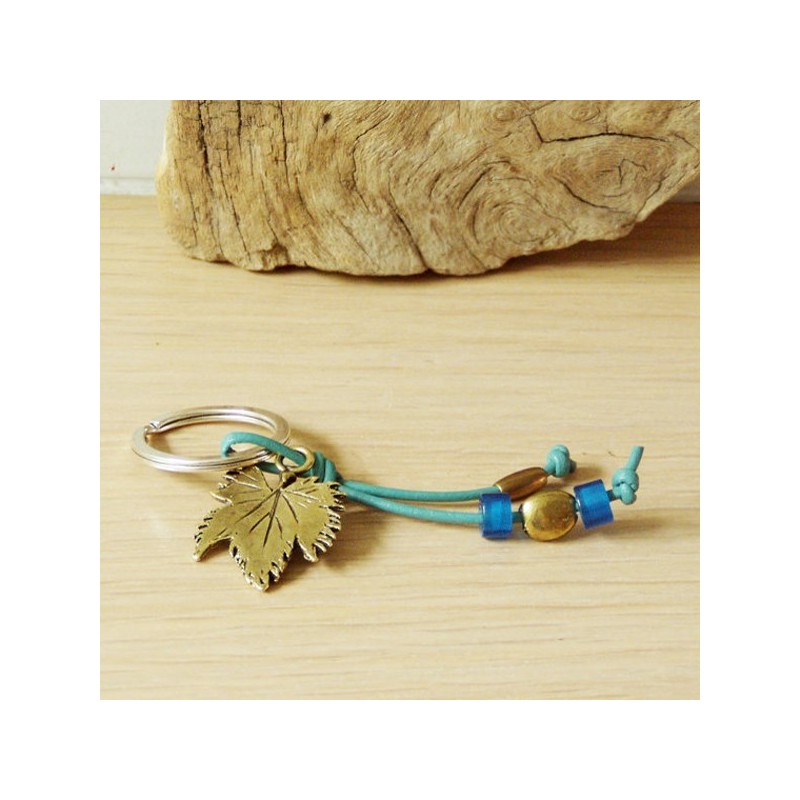 Grapevine keychain, brass grapevine leaf on a blue leather cord with brass and glass beads.