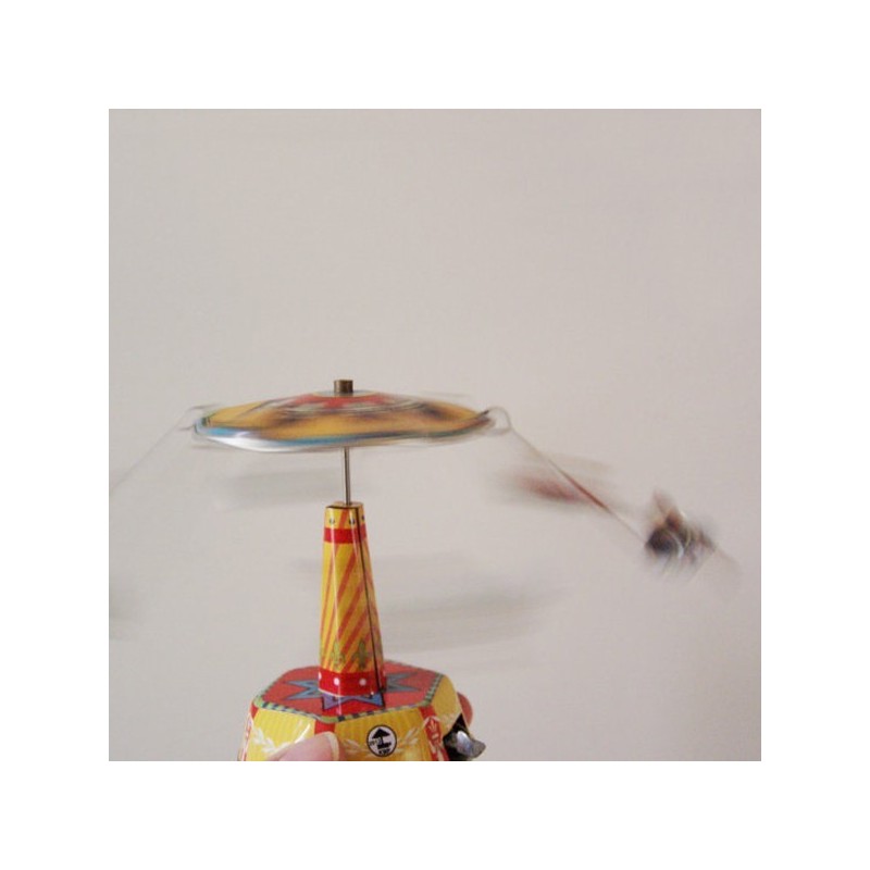 Colourful carousel miniature, tin, merry go round toy with six seated figures, carrousel in red yellow blue