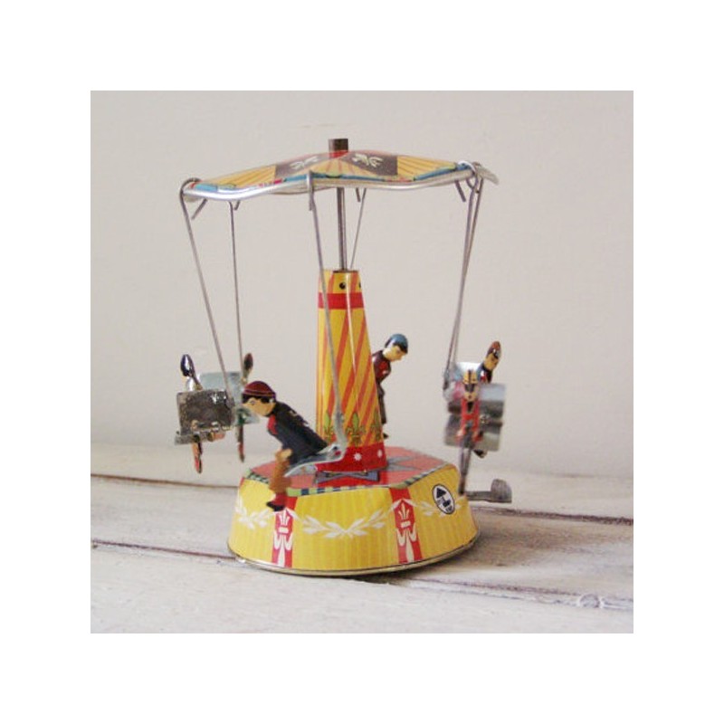 Colourful carousel miniature, tin, merry go round toy with six seated figures, carrousel in red yellow blue
