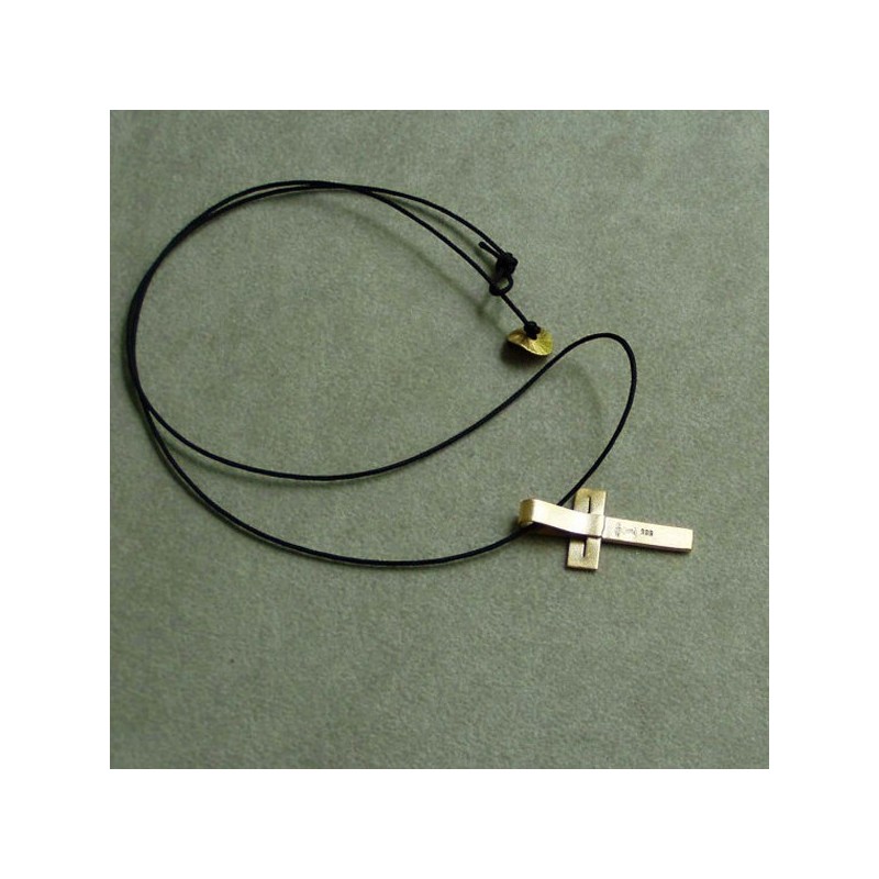 Minimal solid gold cross, modern, unisex, 18 karat gold cross  on a black cord.