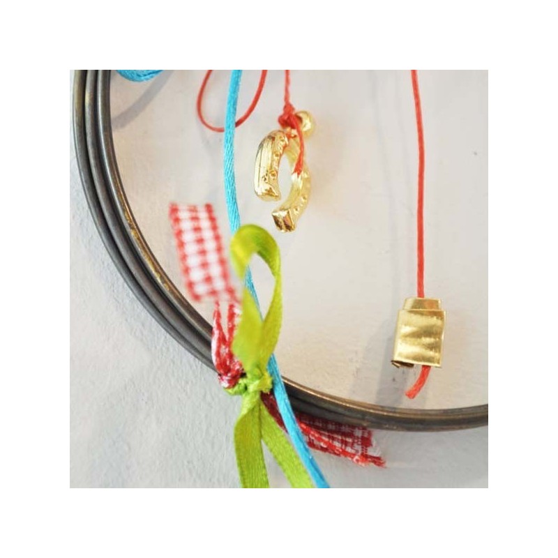 Ceramic pomegranates holiday wreath of bronze wire, ribbons and strings.